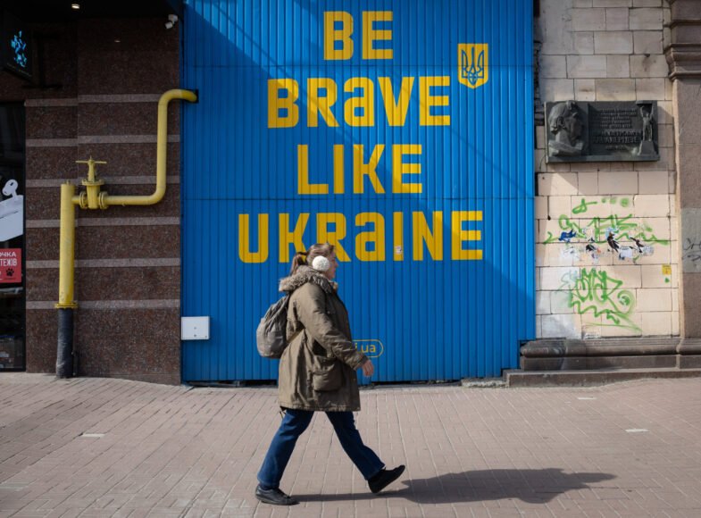 A woman walks near a building with a huge inscription 'Be brave like Ukraine' in central Kyiv. Ukrainian capital is located away from the fighting places, but the presence of war is felt in the city and affects many aspects of the life of local residents. Russian troops entered Ukrainian territory on February 2022, starting a conflict that provoked the destruction of areas and humanitarian crisis.